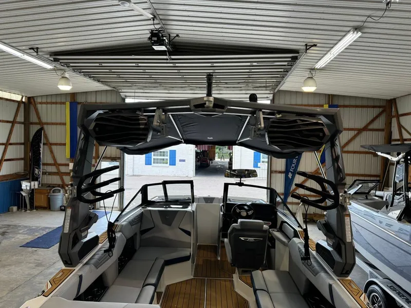 Slide: The Image of 2025 Nautique Super Air Nautique S21 boat interior in a garage setting. - 4