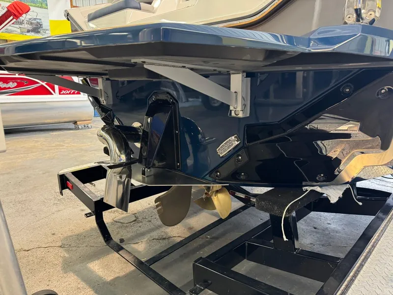 Slide: The Image of 2025 Nautique Super Air Nautique S21 boat propeller and hull on trailer. - 6