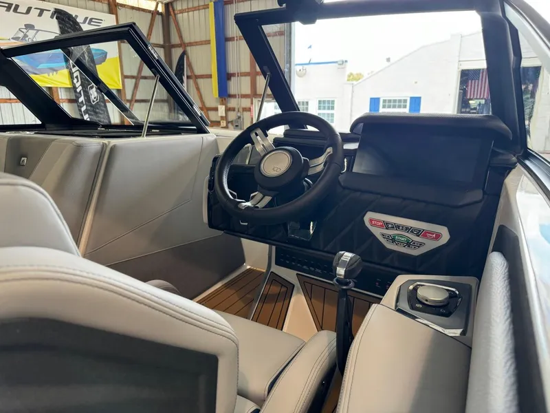 Slide: The Image of 2025 Nautique Super Air Nautique S21 interior with modern steering and dashboard. - 8