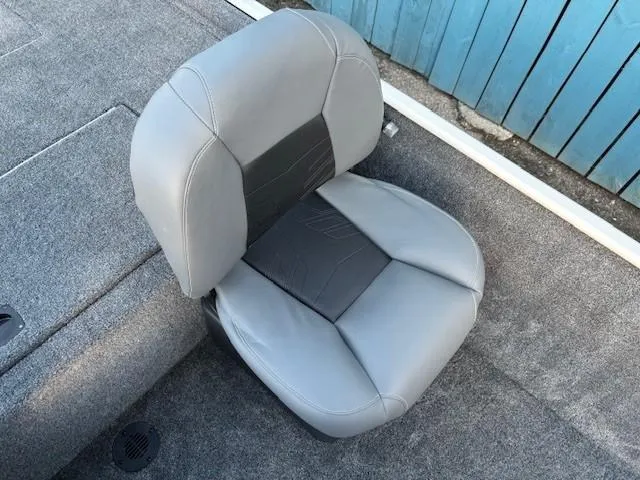 Slide: The Image of 2025 Tracker Bass Tracker Classic XL boat seat, gray upholstery, on carpeted deck. - 13