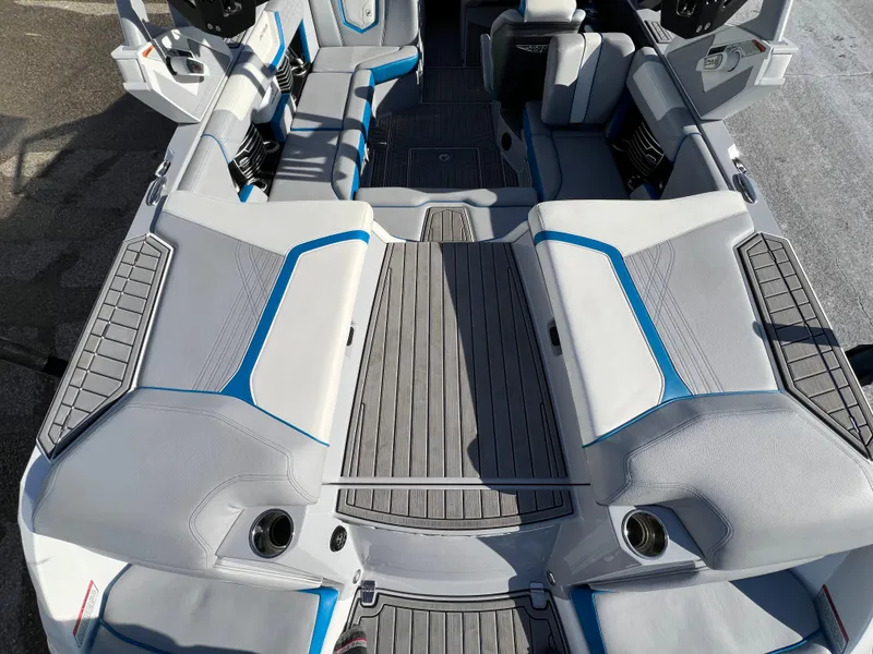 Slide: The Image of 2020 Nautique G21 boat interior with gray and blue seating, spacious layout. - 15