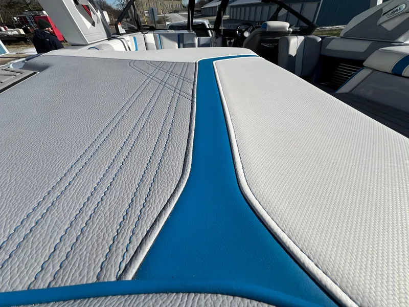 Slide: The Image of 2020 Nautique G21 boat interior with blue and white upholstery detailing. - 16