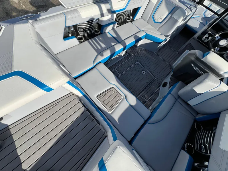 Slide: The Image of 2020 Nautique G21 boat interior with gray and blue seating and modern design. - 17
