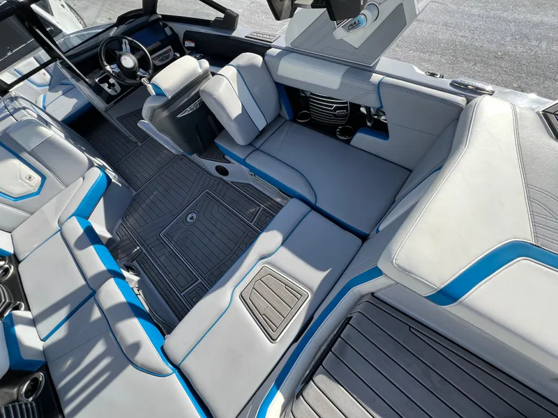 Slide: The Image of 2020 Nautique G21 boat interior with gray and blue seating, modern design. - 18