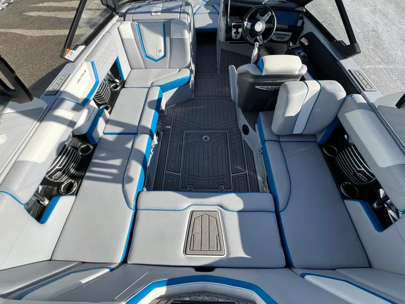 Slide: The Image of 2020 Nautique G21 boat interior with gray and blue seating, modern design. - 19
