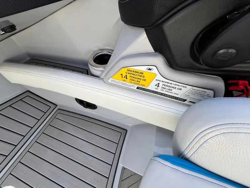 Slide: The Image of 2020 Nautique G21 interior with seating capacity label and cup holder. - 22