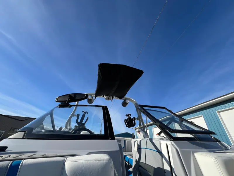 Slide: The Image of 2020 Nautique G21 boat interior with open windshield under clear blue sky. - 31