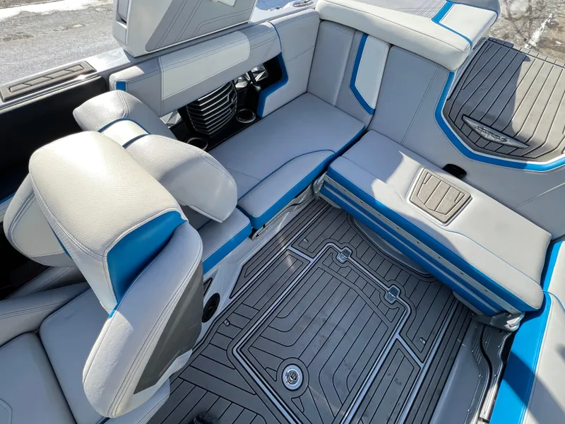 Slide: The Image of 2020 Nautique G21 boat interior with gray and blue seating and flooring. - 34
