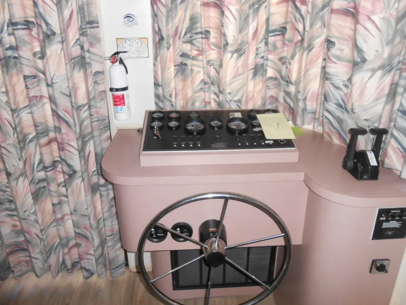 Slide: The Image of 1998 Lakeview 5516 boat helm with steering wheel and control panel. - 13