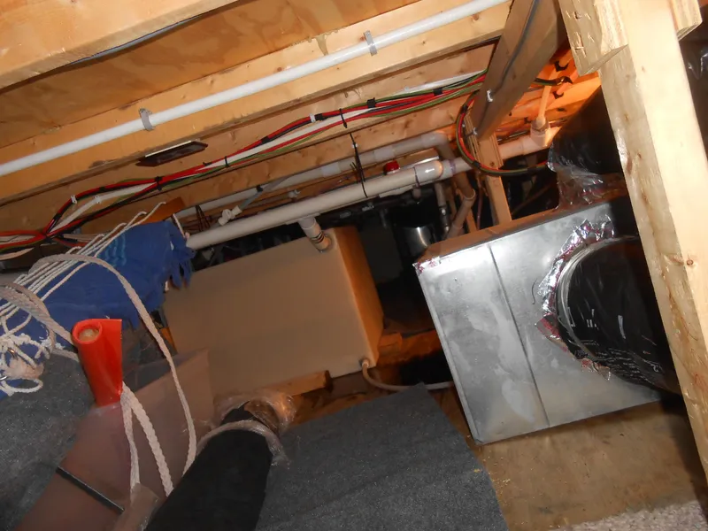 Slide: The Image of Crawl space with pipes and HVAC system in a Lakeview 5516, 1998 model. - 14