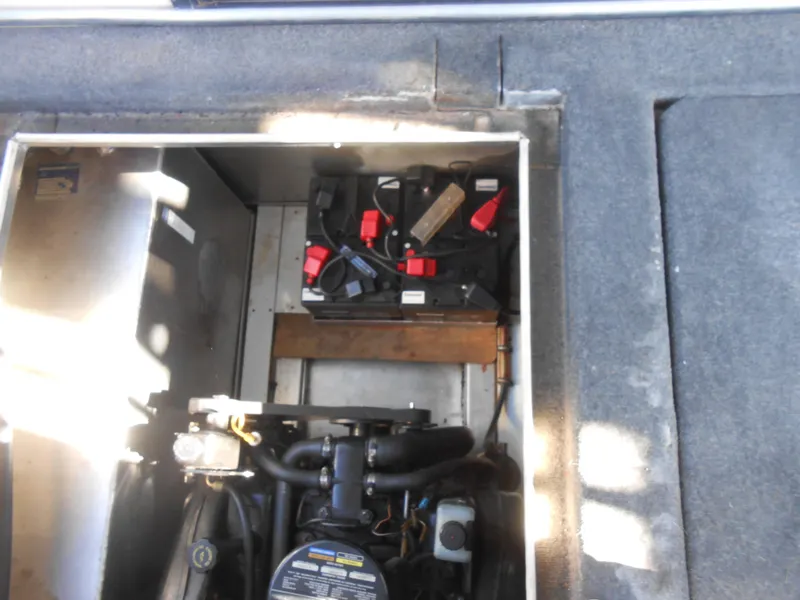 Slide: The Image of Engine compartment of a 1998 Lakeview 5516 boat, showing battery and mechanical components. - 18