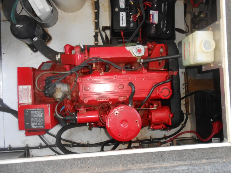 Slide: The Image of Red engine in a 1998 Lakeview 5516 boat, surrounded by wiring and components. - 19