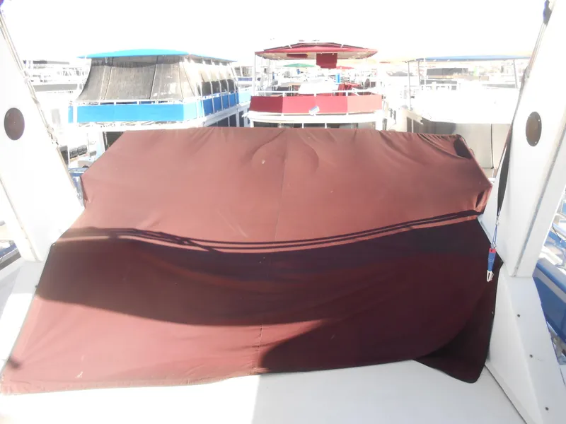Slide: The Image of Covered deck area on 1998 Lakeview 5516 houseboat, surrounded by other boats. - 28