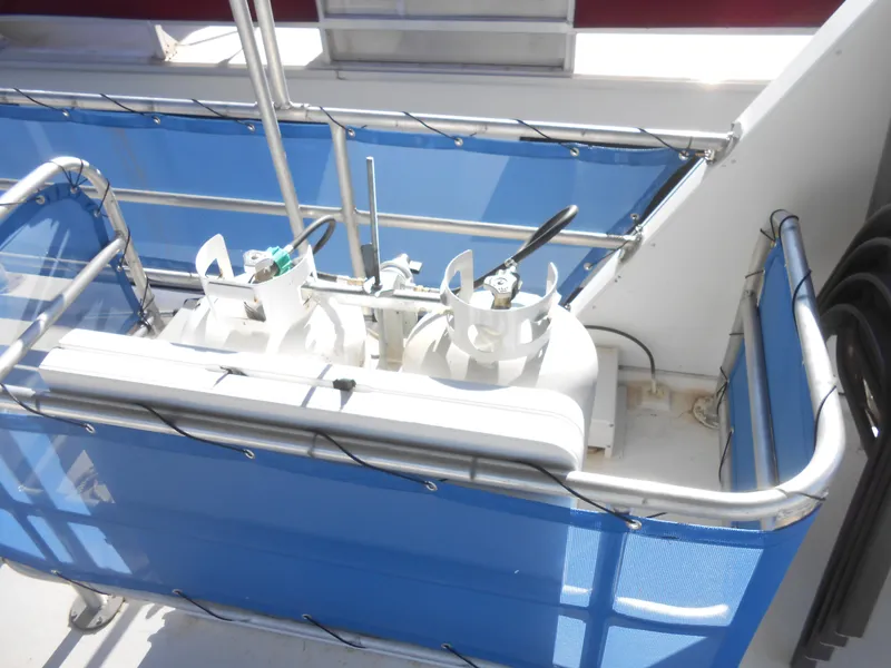 Slide: The Image of Propane tanks on a 1998 Lakeview 5516 boat with blue safety railing. - 30