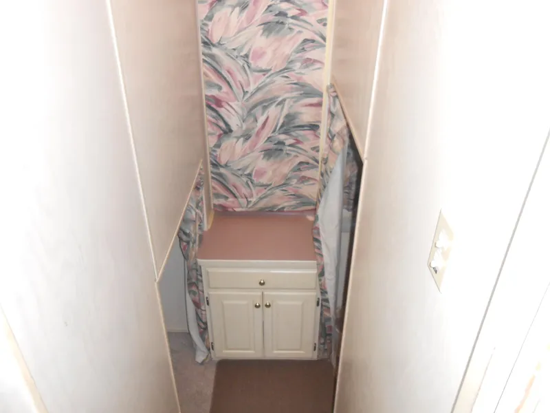 Slide: The Image of Narrow hallway with floral wallpaper and white cabinet, Lakeview 5516 model, 1998. - 8