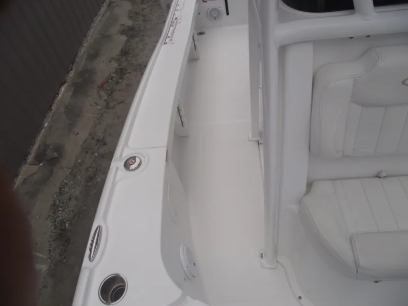 Slide: The Image of 2019 Sea Hunt BX 22 BR boat interior, featuring white seating and deck. - 17