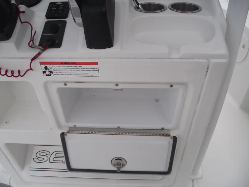 Slide: The Image of 2019 Sea Hunt BX 22 BR boat console with storage compartment and cup holders. - 23