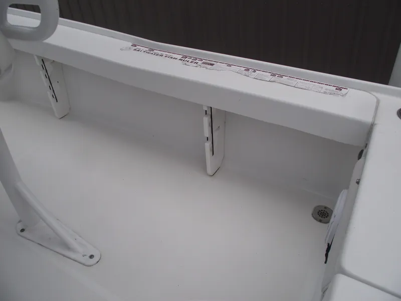 Slide: The Image of 2019 Sea Hunt BX 22 BR boat interior, featuring white seating and storage compartments. - 27