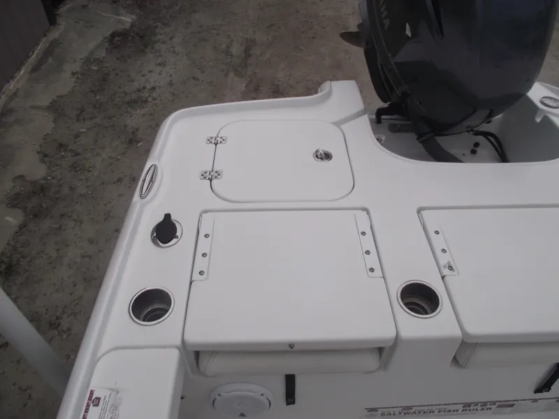 Slide: The Image of 2019 Sea Hunt BX 22 BR boat deck with storage compartments and motor. - 28