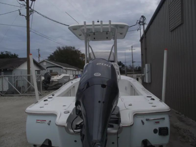 Slide: The Image of 2019 Sea Hunt BX 22 BR boat with powerful outboard motor, parked outdoors. - 4