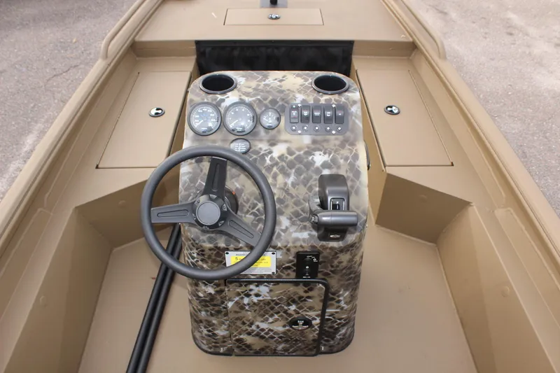 Slide: The Image of 2025 Excel 1860 F4 Shallow Water boat console with camouflage design and steering wheel. - 13