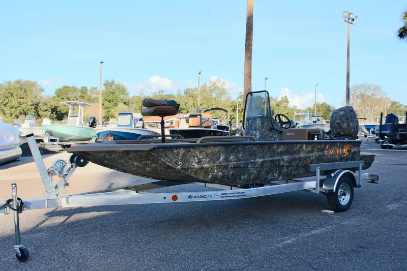 Slide: The Image of 2025 Excel 1860 F4 Shallow Water boat on trailer in parking lot. - 2