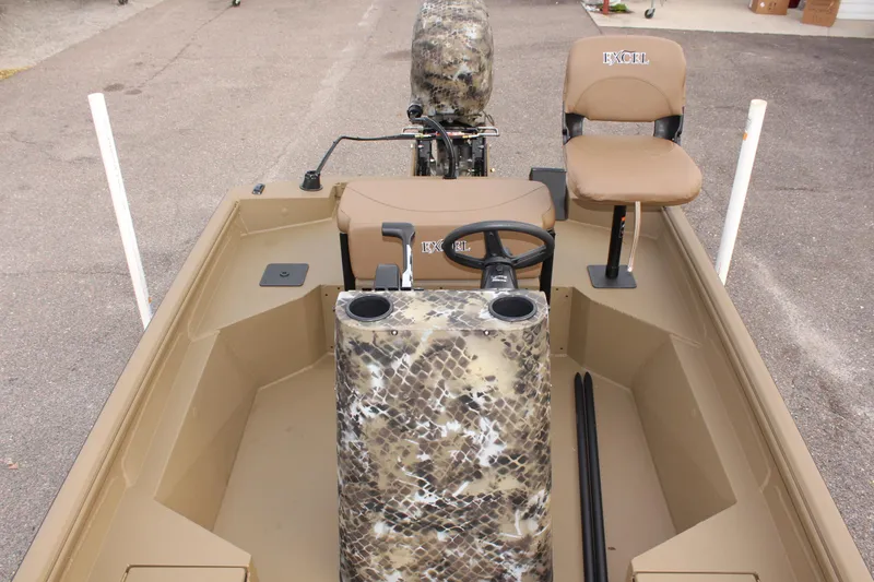 Slide: The Image of 2025 Excel 1860 F4 Shallow Water boat interior with camo design and seating. - 23
