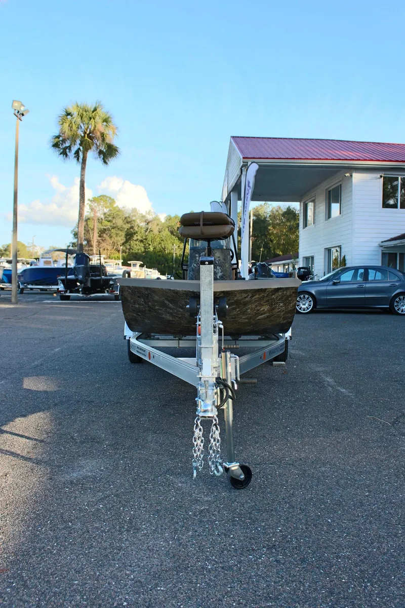 Slide: The Image of 2025 Excel 1860 F4 Shallow Water boat on trailer in parking lot. - 3