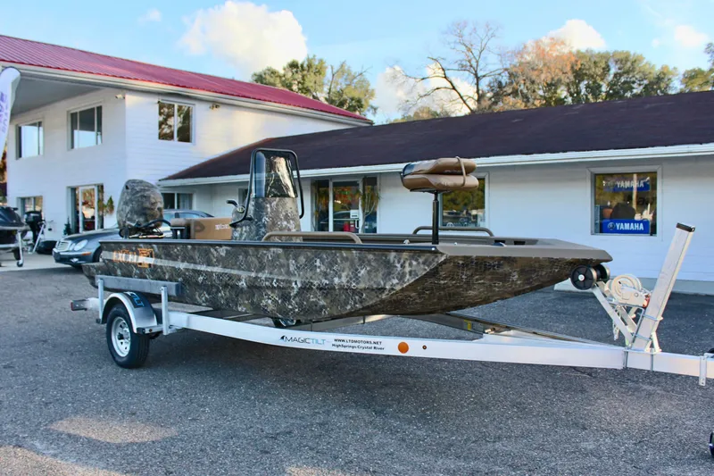 Slide: The Image of 2025 Excel 1860 F4 Shallow Water boat on trailer outside dealership. - 4