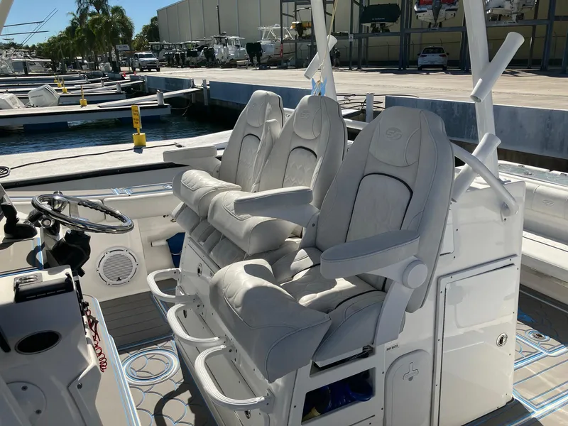 Slide: The Image of 2021 Sea Fox 328 Commander boat with luxurious seating at a marina. - 16