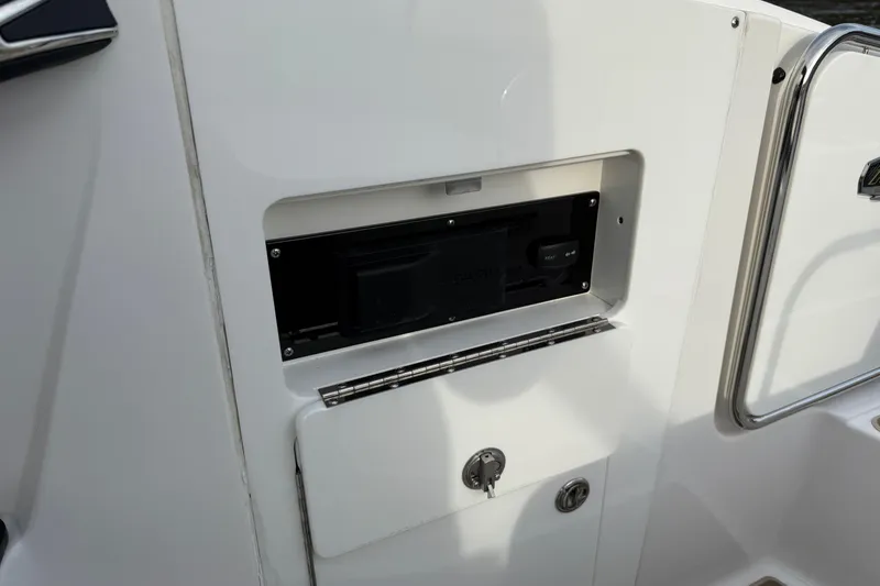 Slide: The Image of 2025 Monterey M6 boat interior detail with storage compartment and control panel. - 10