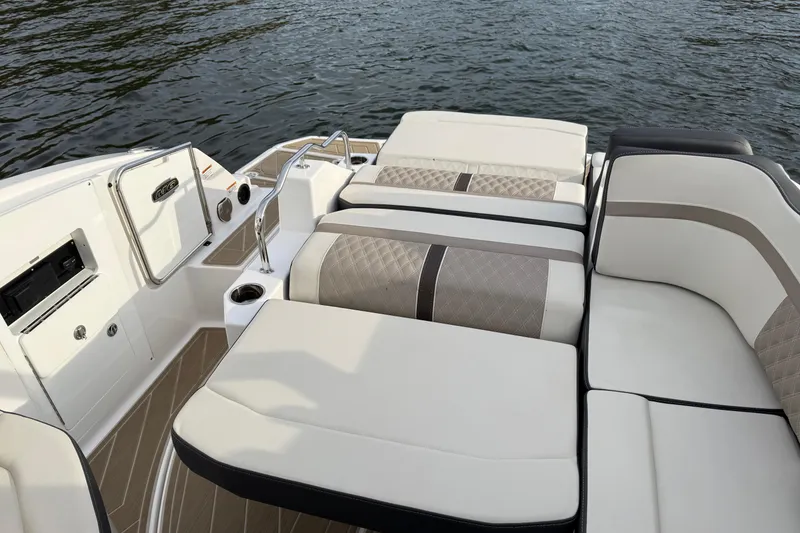 Slide: The Image of 2025 Monterey M6 boat interior with luxurious seating and elegant design on the water. - 11