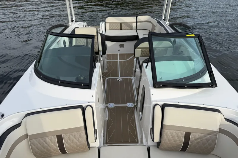 Slide: The Image of 2025 Monterey M6 boat interior with luxurious seating and sleek design on the water. - 12