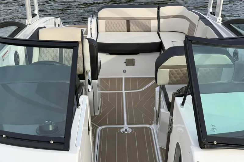 Slide: The Image of 2025 Monterey M6 boat interior with luxurious seating and sleek design on the water. - 13