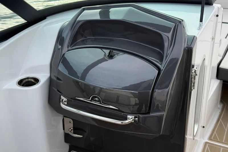 Slide: The Image of 2025 Monterey M6 boat dashboard with sleek black design and chrome accents. - 25