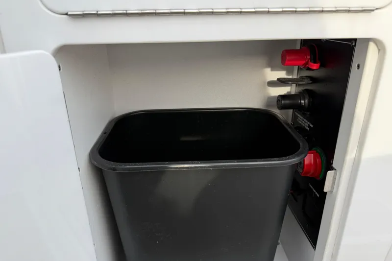 Slide: The Image of Interior compartment of 2025 Monterey M6 with black trash bin and control panel. - 26
