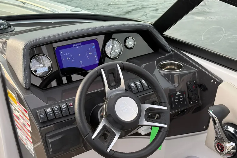 Slide: The Image of 2025 Monterey M6 boat dashboard with steering wheel, digital display, and control panel. - 27