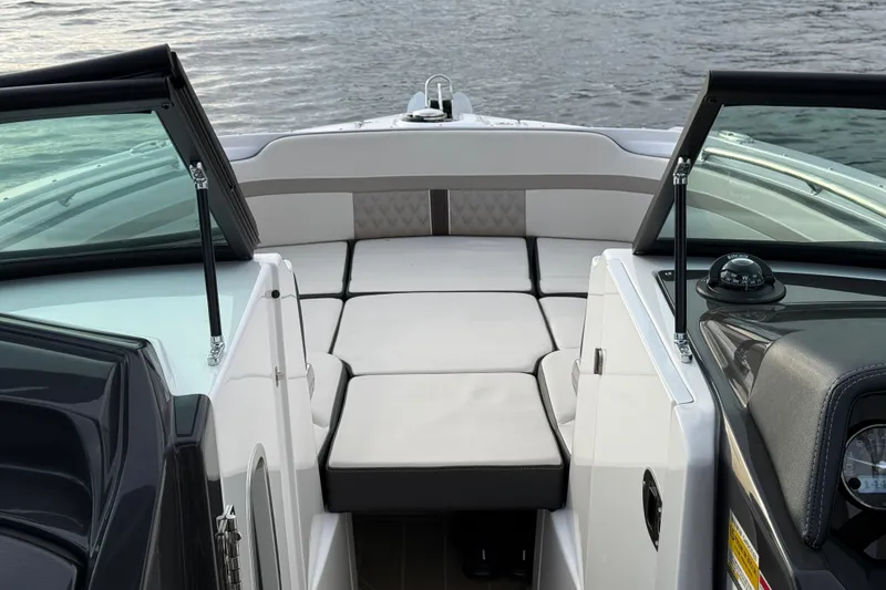Slide: The Image of 2025 Monterey M6 boat interior with cushioned seating and open water view. - 28
