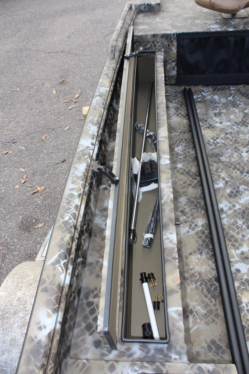 Slide: The Image of 2025 Excel 1860 F4 Shallow Water boat with camo design and rod storage compartment. - 16