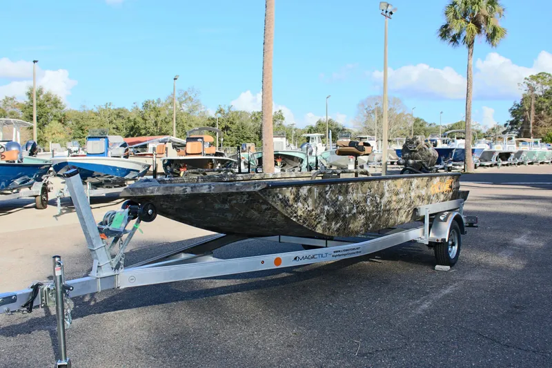 Slide: The Image of 2025 Excel 1860 F4 Shallow Water boat on trailer in outdoor lot. - 2