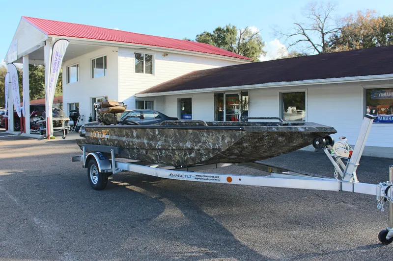 Slide: The Image of 2025 Excel 1860 F4 Shallow Water boat on trailer outside dealership. - 4