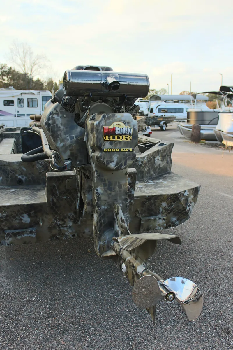 Slide: The Image of 2025 Excel 1860 F4 Shallow Water boat with powerful motor in a marina setting. - 8