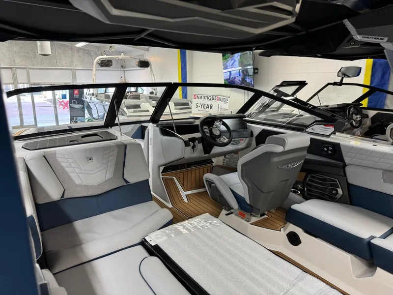 Slide: The Image of Interior of 2024 Nautique Super Air Nautique G23 boat, featuring modern seating and dashboard. - 12