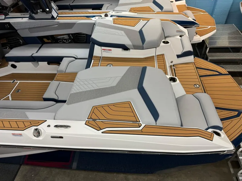 Slide: The Image of 2024 Nautique Super Air Nautique G23 boat interior with sleek seating and wood accents. - 22