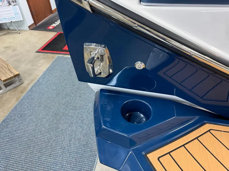Slide: The Image of 2024 Nautique Super Air Nautique G23 boat detail with blue and wood accents. - 25