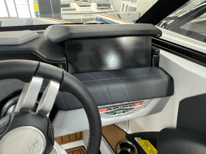 Slide: The Image of 2024 Nautique Super Air Nautique G23 dashboard with steering wheel and touchscreen display. - 33