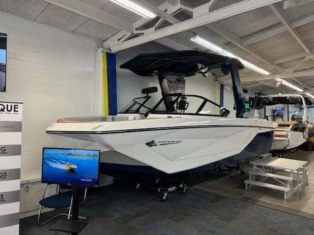 Slide: The Image of 2024 Nautique Super Air Nautique G23 boat displayed in showroom with promotional screen. - 4