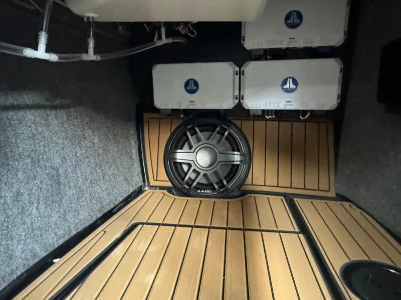 Slide: The Image of 2024 Nautique Super Air Nautique G23 interior with premium sound system and wood flooring. - 43