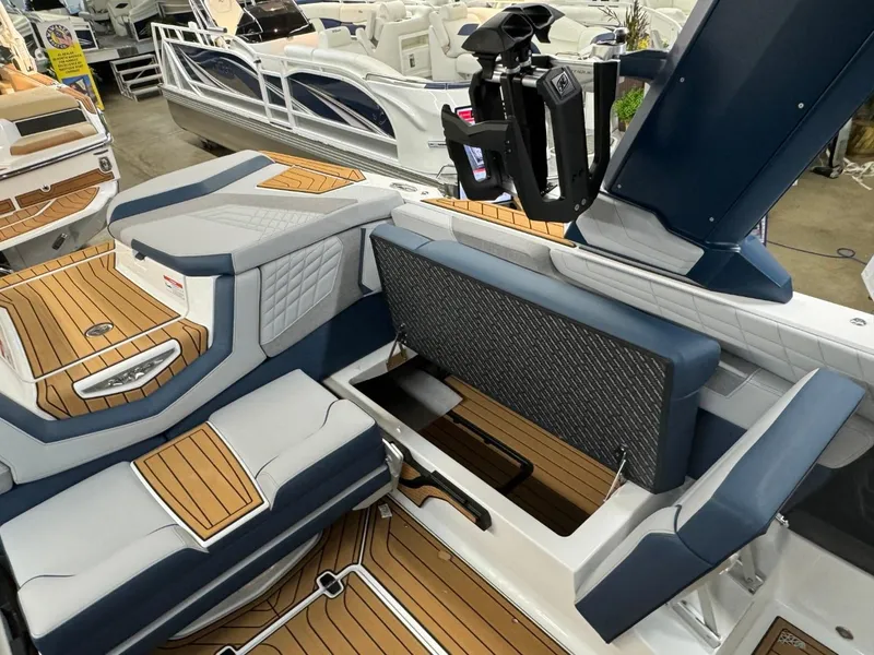 Slide: The Image of 2024 Nautique Super Air Nautique G23 interior with luxurious seating and teak flooring. - 44