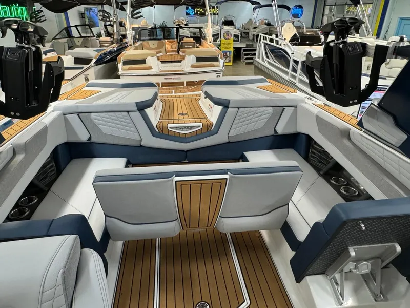 Slide: The Image of 2024 Nautique Super Air Nautique G23 interior with luxurious seating and teak flooring. - 45